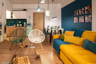 a living room with a yellow couch and a table at Alsalos Sea View Apartment in Chania Town