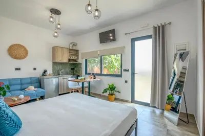 a living room with a bed and a kitchen at Cavos Luxury Apartments in Kissamos