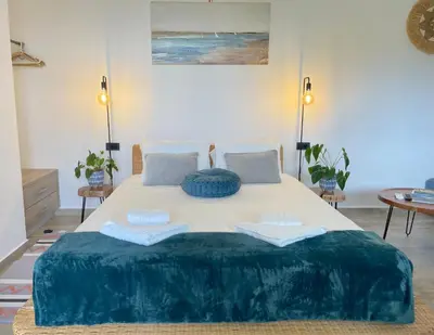a bedroom with a large bed with two pillows on it at Cavos Luxury Apartments in Kissamos