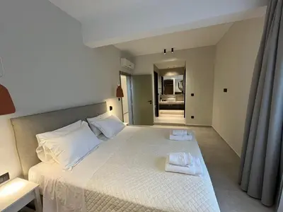 a bedroom with a large bed with two towels on it at Mediterranean Sea Top Floor in Palaiochóra