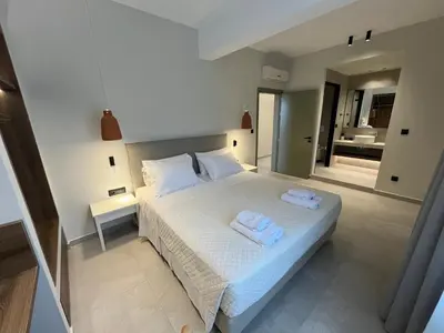 a bedroom with a bed with two towels on it at Mediterranean Sea Top Floor in Palaiochóra