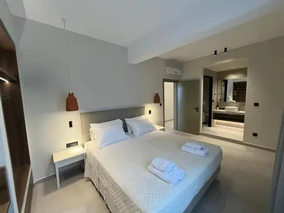 a bedroom with a bed with two towels on it at Mediterranean Sea Top Floor in Palaiochóra