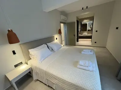 a bedroom with a bed with two towels on it at Mediterranean Sea Top Floor in Palaiochóra