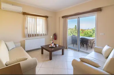 a living room with a couch and a table at Selini Villas with private pool 10 minutes walking from the beach in Ropanianá