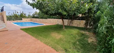a backyard with a swimming pool and a tree at Selini Villas with private pool 10 minutes walking from the beach in Ropanianá