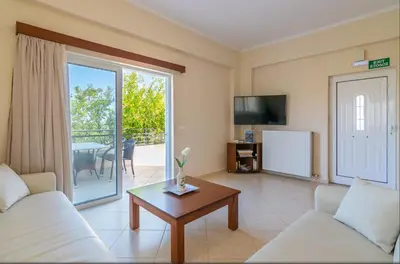 a living room with a couch and a table at Selini Villas with private pool 10 minutes walking from the beach in Ropanianá