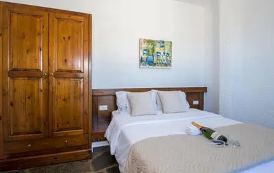 a bedroom with two beds and a bottle on the bed at Folia Apartments Chania in Agia Marina Nea Kydonias