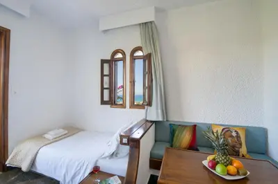 a room with a bed and a table with a bowl of fruit at Folia Apartments Chania in Agia Marina Nea Kydonias