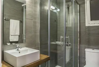 a bathroom with a sink and a glass shower at Sea View Hotel & Apartments in Kato Daratso