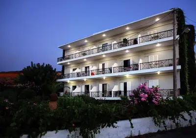 a large white building with balconies and flowers at Sea View Hotel & Apartments in Kato Daratso