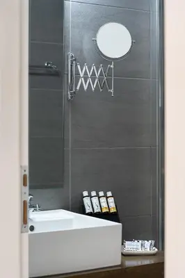 a bathroom with a sink and a mirror at Sea View Hotel & Apartments in Kato Daratso