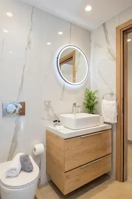 a bathroom with a sink and a toilet and a mirror at Annet in Chania Town
