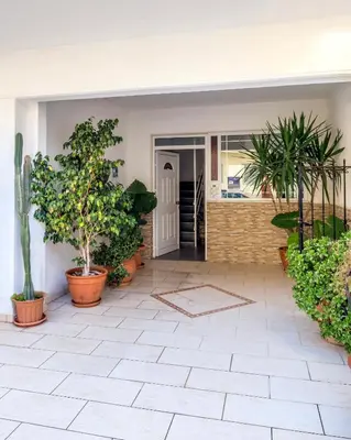 a courtyard with potted plants in a house at Annet in Chania Town