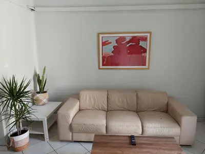 a living room with a couch and a table at Sonia cyclamen in Chania Town