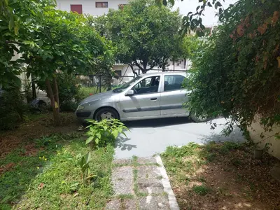 a silver car parked on the side of a street at Sonia cyclamen in Chania Town