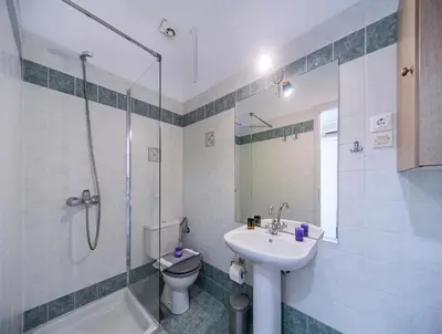 a bathroom with a sink and a toilet and a shower at Casa Kasteli in Chania Town