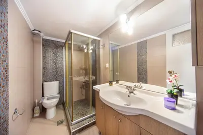 a bathroom with a sink and a toilet at Casa Kasteli in Chania Town