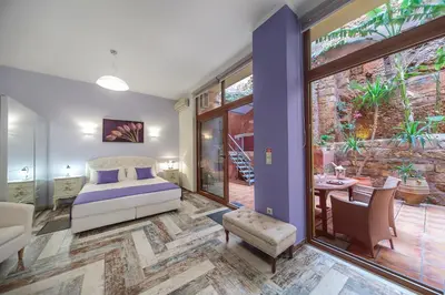 a bedroom with a bed and a patio at KasteliSuites in Chania Town