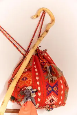 a red purse with two wooden sticks in it at KasteliSuites in Chania Town