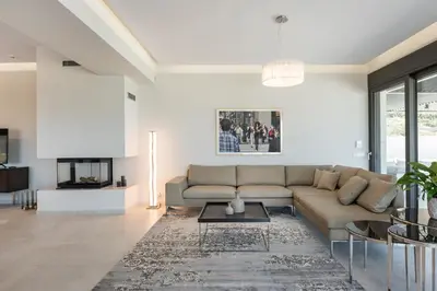 a living room with a couch and a table at Villa Pirgos Luxury in Kissamos