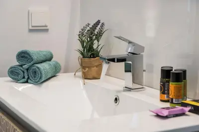 a bathroom counter with a sink with towels and a faucet at Villa Pirgos Luxury in Kissamos