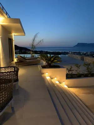 a patio with lights on the side of a building at Villa Pirgos Luxury in Kissamos