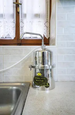 a mixer sitting on a kitchen counter next to a sink at Suite Maritime in Chania Town