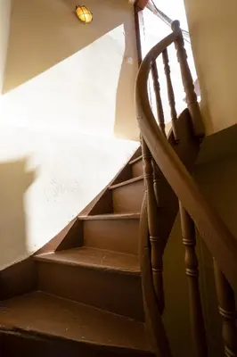 a set of stairs with a wooden stair railing at Suite Maritime in Chania Town