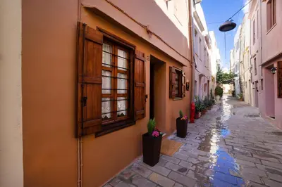 an alley with buildings and potted plants on a street at Suite Maritime in Chania Town