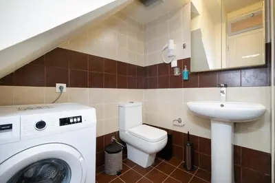 a bathroom with a washing machine and a sink at Suite Maritime in Chania Town