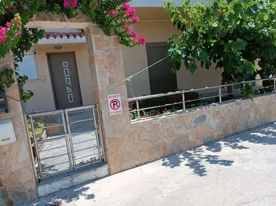 a building with a no parking sign in front of it at Casa.Costiera in Palaiochóra