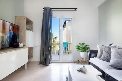 a living room with a couch and a tv at Casa Maria 300 meters from the sea in Chania Town
