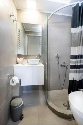 a bathroom with a shower and a sink and a toilet at Casa Maria 300 meters from the sea in Chania Town