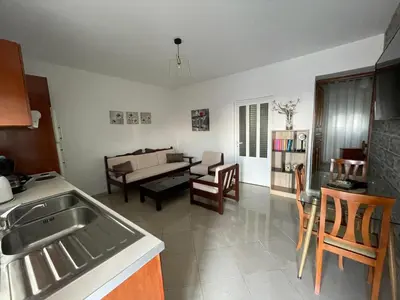 a kitchen and living room with a sink and a table at Claudia villa 2 in Agia Marina Nea Kydonias