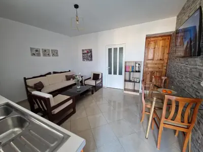 a living room with a couch and a table at Claudia villa 2 in Agia Marina Nea Kydonias