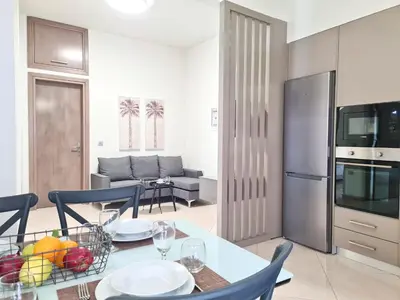 a kitchen and living room with a table and chairs at Anna & Zampia central apts in Kissamos