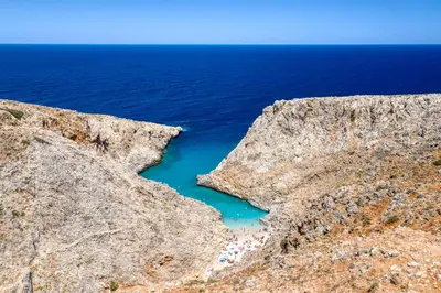 a view of the ocean between two rocky cliffs at Stema City Apartment in Chania Town