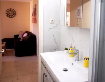 a bathroom with a sink and a mirror at Charming apartment in Halepa! in Chania Town