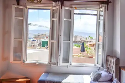 an open window with a view of a city at Bozzali Deluxe Hotel in Chania Town