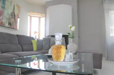 a living room with a glass table with a vase at Kallia's Modern Apartment in Kissamos