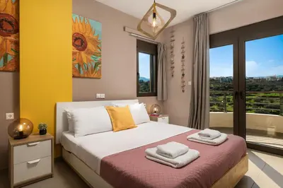 a bedroom with a bed with towels on it at Halepa Luxury Apartments in Chania Town