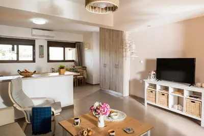 a living room with a television and a table at Halepa Luxury Apartments in Chania Town