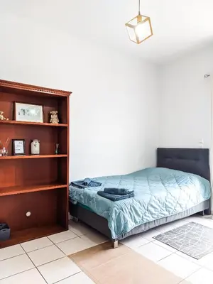 a bedroom with a bed and a book shelf at Beautiful apartment in Chania in Chania Town