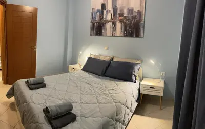 a bedroom with a bed and a painting on the wall at Centro Apartment in Chania Town