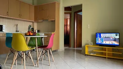 a kitchen with a table and chairs and a television at Centro Apartment in Chania Town