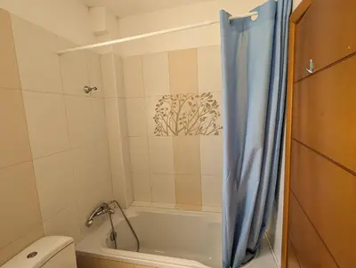 a bathroom with a bath tub and a toilet at Tamar's place in Chania Town