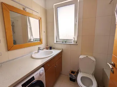 a bathroom with a sink and a toilet and a mirror at Tamar's place in Chania Town
