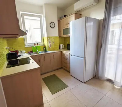 a kitchen with a white refrigerator and a window at Tamar's place in Chania Town