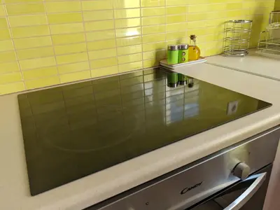 a kitchen with a counter top with a glass window at Tamar's place in Chania Town