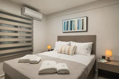 a bedroom with a bed with two towels on it at 2 bd downtown home with private parking 400 meters walk to the beach in Chania Town